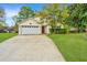 Inviting home exterior with a well-manicured lawn, long driveway, and a two-car garage at 1312 Belle Grove Cir, Hanahan, SC 29410