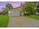 Charming single-Gathering home with a two-car garage, a long driveway, and mature trees in a well-manicured front yard at 1312 Belle Grove Cir, Hanahan, SC 29410