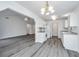 Well-lit kitchen with white cabinetry, gray countertops, and appliances overlooking the dining and living areas at 1312 Belle Grove Cir, Hanahan, SC 29410