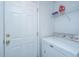 A functional laundry area with a modern white dryer and storage shelf for organization at 1312 Belle Grove Cir, Hanahan, SC 29410