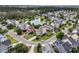 Expansive aerial view of a neighborhood near the water with a beautiful pond surrounded by lush greenery and homes at 138 Sandshell Dr, Charleston, SC 29492