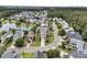 Stunning aerial view showcases charming homes near the water with lush landscaping, tranquil pond views, and mature trees at 138 Sandshell Dr, Charleston, SC 29492