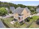 Aerial view of the home with a fenced-in yard, patio, and lush landscaping at 138 Sandshell Dr, Charleston, SC 29492