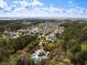 Scenic aerial view of a residential neighborhood, pool area, lake, and wooded landscape at 138 Sandshell Dr, Charleston, SC 29492