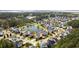 Scenic aerial view of this neighborhood featuring colorful homes around a tranquil pond with lush landscaping at 138 Sandshell Dr, Charleston, SC 29492