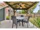 Charming back patio features a gorgeous ceiling fan, outdoor lighting, and outdoor dining set with seating for four at 138 Sandshell Dr, Charleston, SC 29492