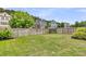 Spacious backyard with a well-maintained lawn, wooden fence and surrounding homes at 138 Sandshell Dr, Charleston, SC 29492