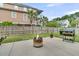 Backyard with fire pit, BBQ, green lawn, and privacy fence, ideal for outdoor living and entertaining at 138 Sandshell Dr, Charleston, SC 29492
