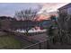 Scenic backyard view featuring a serene lake at sunset and mature trees at 138 Sandshell Dr, Charleston, SC 29492