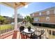 Relaxing covered balcony with seating, overlooking a tranquil lake and lush greenery at 138 Sandshell Dr, Charleston, SC 29492