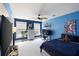 Vibrant bedroom with blue walls, a ceiling fan, and a cozy bed at 138 Sandshell Dr, Charleston, SC 29492