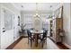 Cozy dining area with rustic table, bright light from the window, and a decorative cabinet at 138 Sandshell Dr, Charleston, SC 29492