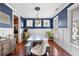 Traditional dining room featuring shiplap walls, wood floors, and a light-filled, window-lined space at 138 Sandshell Dr, Charleston, SC 29492