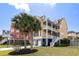 Stunning two-story yellow home with double balconies, landscaped yard, and a two-car garage at 138 Sandshell Dr, Charleston, SC 29492