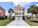 Attractive two-story yellow home with a two-car garage and a basketball hoop, set in a well-kept lawn at 138 Sandshell Dr, Charleston, SC 29492