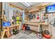 Organized unfinished garage with work tables, tools, and storage, perfect for hobbies and projects at 138 Sandshell Dr, Charleston, SC 29492