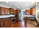 Gourmet kitchen boasting stainless steel appliances, cherry wood cabinetry, and hardwood flooring throughout at 138 Sandshell Dr, Charleston, SC 29492