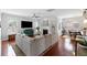 Bright living room features a fireplace, large sectional sofa, hardwood floors, and view to the dining room at 138 Sandshell Dr, Charleston, SC 29492