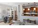Open-concept living room and kitchen boasting hardwood floors, a dining table, and modern appliances at 138 Sandshell Dr, Charleston, SC 29492