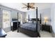Spacious primary bedroom with a four-poster bed, a ceiling fan, and lots of natural light at 138 Sandshell Dr, Charleston, SC 29492