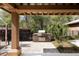 Outdoor grilling area on a brick-paved patio with stainless steel grill and lush landscaping at 138 Sandshell Dr, Charleston, SC 29492
