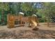 Community playground featuring a climbing wall, slides, and a wooden play structure at 138 Sandshell Dr, Charleston, SC 29492