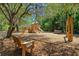 Community playground with a climbing structure, slide, picnic table, and benches at 138 Sandshell Dr, Charleston, SC 29492
