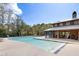 Expansive community pool area with lounge chairs, umbrellas, and a covered pavilion at 138 Sandshell Dr, Charleston, SC 29492