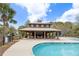 Relax in the community pavilion with fireplace and seating, overlooking the pool area at 138 Sandshell Dr, Charleston, SC 29492