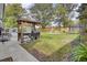 Lush backyard with grill station, seating area, trampoline, and playground at 1406 Iroquois St, North Charleston, SC 29405