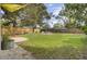Expansive backyard with a well-maintained lawn, playground, and privacy fence at 1406 Iroquois St, North Charleston, SC 29405