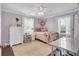 Cozy bedroom with neutral tones, ceiling fan and natural light at 1406 Iroquois St, North Charleston, SC 29405