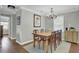 An elegant dining room features hardwood floors, a chandelier, and a wooden dining table with seating for six at 1406 Iroquois St, North Charleston, SC 29405