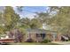 Charming brick home with a well-maintained lawn, mature trees, and classic black window shutters at 1406 Iroquois St, North Charleston, SC 29405