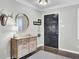 Stylish foyer with hardwood floors, decorative mirror and accents, and a coat rack at 1406 Iroquois St, North Charleston, SC 29405