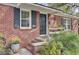 Charming brick home with a black front door, black shutters, and landscaped entrance at 1406 Iroquois St, North Charleston, SC 29405