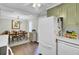 Kitchen and dining room combo offers hardwood floors, dining area with a chandelier, and a refrigerator at 1406 Iroquois St, North Charleston, SC 29405