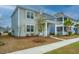 Street view of a well kept gray two story home with a inviting covered front porch and clean sidewalk at 143 Brant Dr, Summerville, SC 29483