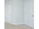 Hallway with neutral walls, plush carpet, and two white doors at 143 Brant Dr, Summerville, SC 29483