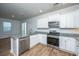 Bright kitchen features granite countertops, stainless steel appliances and white cabinets at 143 Brant Dr, Summerville, SC 29483