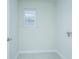 Clean and well-lit laundry room with window and tiled flooring at 143 Brant Dr, Summerville, SC 29483