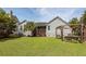 View of the home's rear exterior, showing the lawn, landscaping, and patio at 1433 Oakhurst Dr, Mount Pleasant, SC 29466