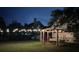 Backyard at night featuring a fire pit and swing illuminated with string lights at 1433 Oakhurst Dr, Mount Pleasant, SC 29466