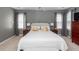 Well-lit bedroom featuring neutral walls, bedside tables, a large bed, and a padded bench at 1433 Oakhurst Dr, Mount Pleasant, SC 29466