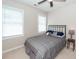 Bedroom showcasing two bright windows, a ceiling fan, and a comfortable bed with gray bedding at 1433 Oakhurst Dr, Mount Pleasant, SC 29466