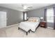 Spacious bedroom with a ceiling fan, large bed, and two windows covered with decorative curtains at 1433 Oakhurst Dr, Mount Pleasant, SC 29466