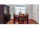Dining area with dark wood table, four chairs, cabinet, and natural light from window at 1433 Oakhurst Dr, Mount Pleasant, SC 29466