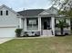 Charming home with a landscaped yard and a welcoming front porch with beautiful flowers at 1433 Oakhurst Dr, Mount Pleasant, SC 29466