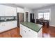 Well-lit kitchen with white cabinets, stainless steel fridge, and island with green countertop at 1433 Oakhurst Dr, Mount Pleasant, SC 29466