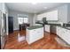 Bright kitchen with white cabinets, stainless steel appliances, central island, and hardwood flooring at 1433 Oakhurst Dr, Mount Pleasant, SC 29466
